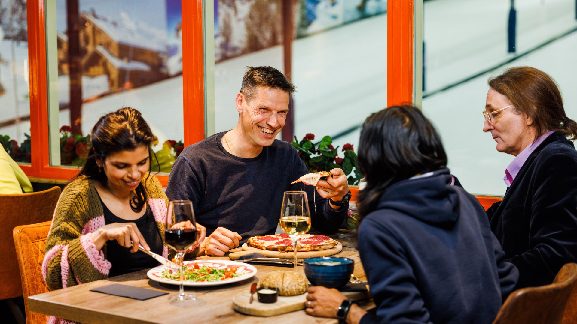 Dine together in the restaurant overlooking the slopes.