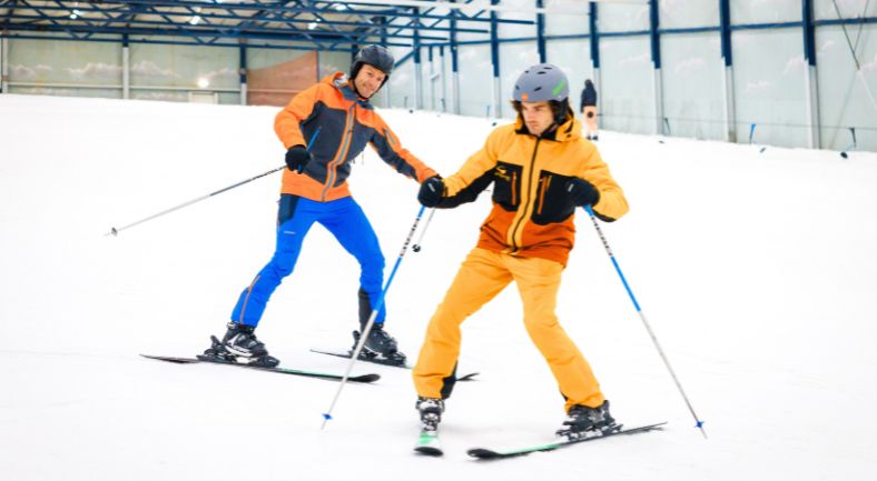 Student receives individual attention from ski instructor during private ski lesson.